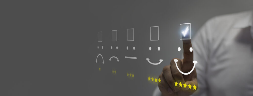 Businessman pressing smiley face emoticon on virtual touch screen. Customer service evaluation concep